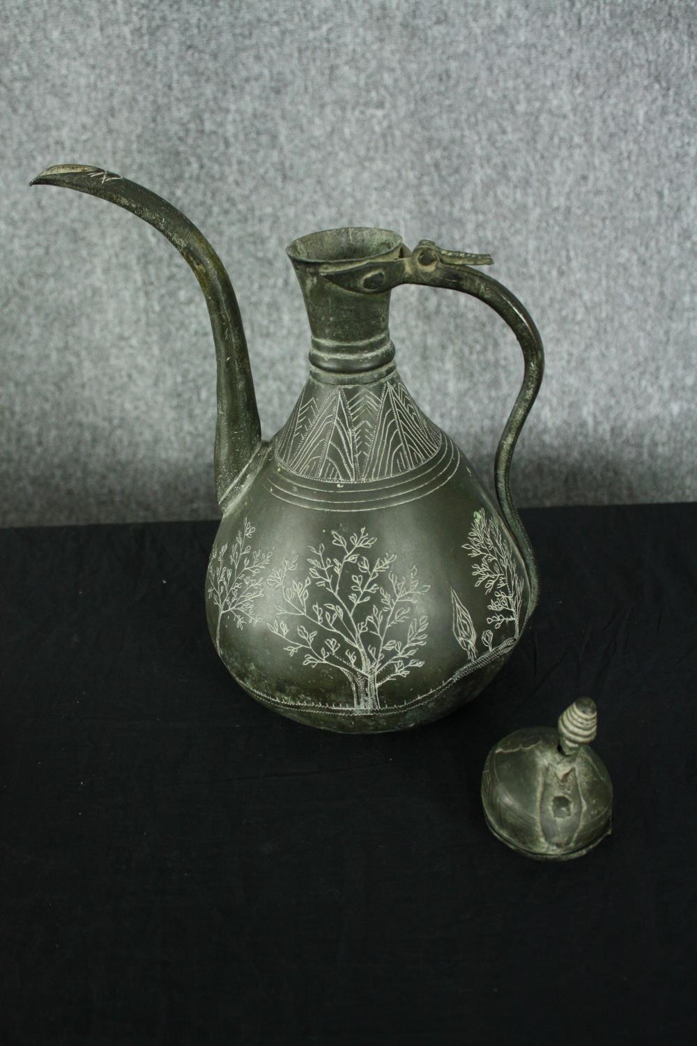 A 19th century Persian bronzed metal ewer with etched foliate and figural design along with a - Image 7 of 8