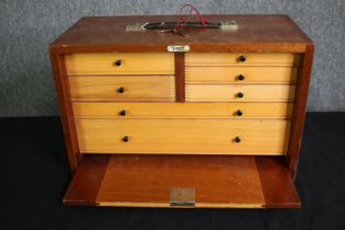 A mid century teak fitted specimen cabinet with maker's label. H.29 W.45 D.22cm.