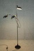 A contemporary vintage style floor standing lamp with articulated arms. H.194cm.