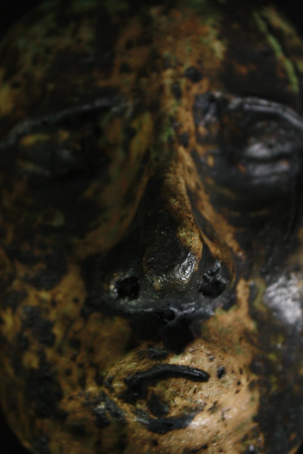 A ceramic glazed bust; man's head on ebonised socle. H.23cm. - Image 5 of 5