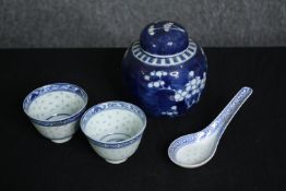 Two small blue and white Chinese tea bowls and spoons along with a blue and white Chinese prunus