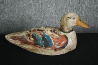 A vintage carved and painted decoy duck. H.13 W.30 D.13cm.