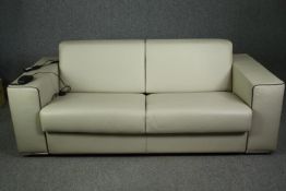 A contemporary Italian sofa bed by Giannini design in piped leather with motorized action. 4' 6"