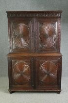 An early 19th century Anglo Indian carved hardwood linen press in two sections. H.190 W.126 D.50cm.