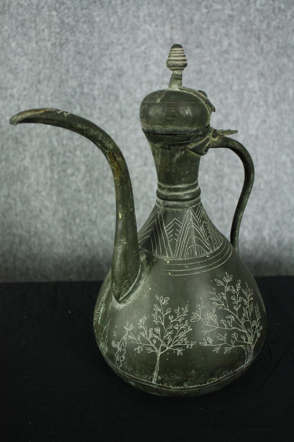 A 19th century Persian bronzed metal ewer with etched foliate and figural design along with a - Image 3 of 8