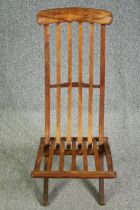 A folding slatted teak side chair. H.93cm.