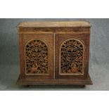 A 19th century Anglo Indian side cabinet, carved and pierced hardwood on plinth base. H.90 W.105 D.