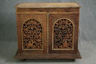 A 19th century Anglo Indian side cabinet, carved and pierced hardwood on plinth base. H.90 W.105 D.