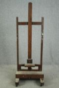 An oak adjustable studio easel, C.1900. H.173 W.161 D.58cm.