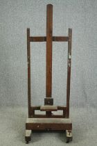 An oak adjustable studio easel, C.1900. H.173 W.161 D.58cm.