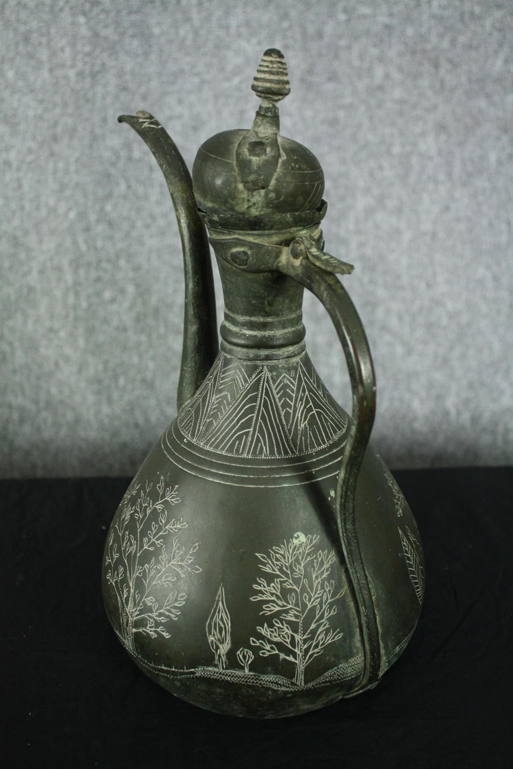 A 19th century Persian bronzed metal ewer with etched foliate and figural design along with a - Image 4 of 8