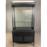 A contemporary two section shop display cabinet. H.211 W.106 D.51cm.