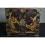 A Chinoiserie lacquered fitted table cabinet. H.32 W.36 D.19cm.