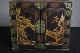 A Chinoiserie lacquered fitted table cabinet. H.32 W.36 D.19cm.