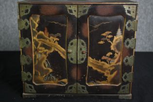 A Chinoiserie lacquered fitted table cabinet. H.32 W.36 D.19cm.