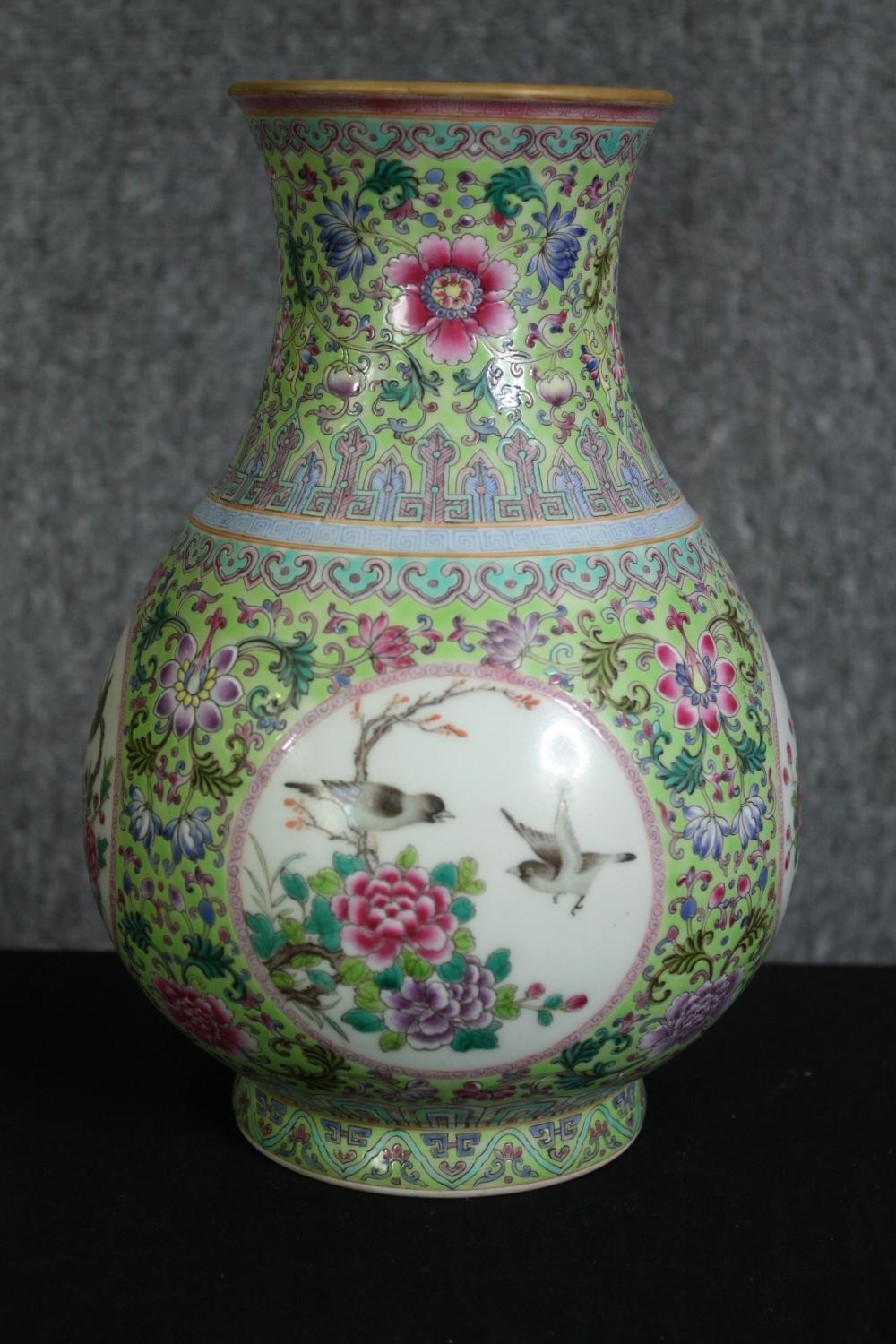 An early 20th century Famille rose hand painted porcelain vase with celadon glaze interior and base.