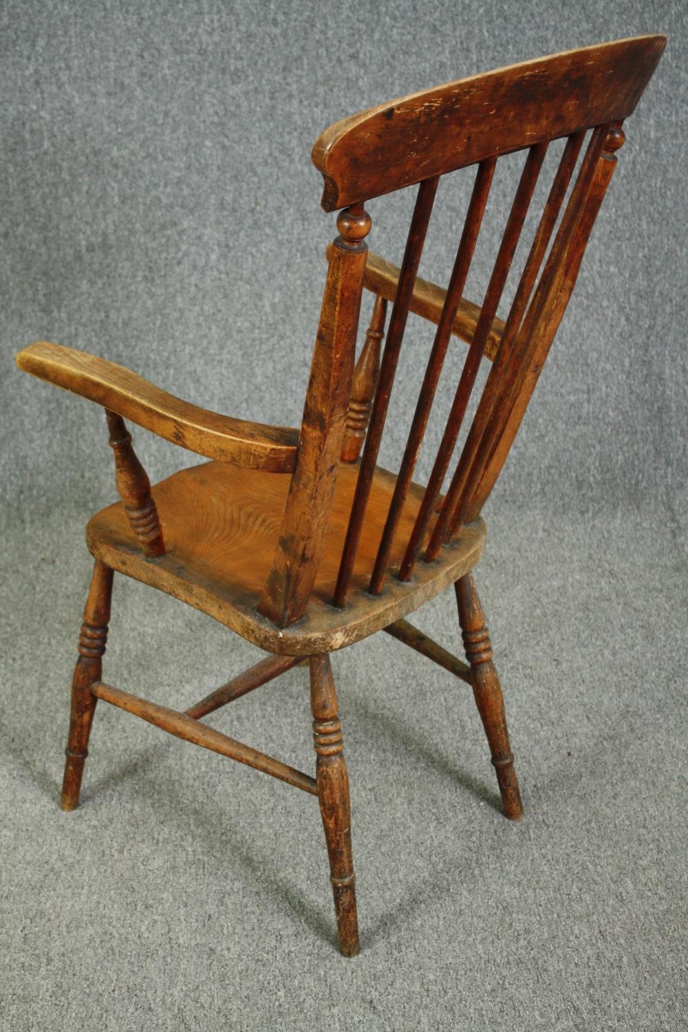 A 19th century elm seated stick back kitchen chair. - Image 5 of 5