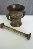 A 19th century Dutch bronze mortar and a brass pestle. L.18cm. (largest).