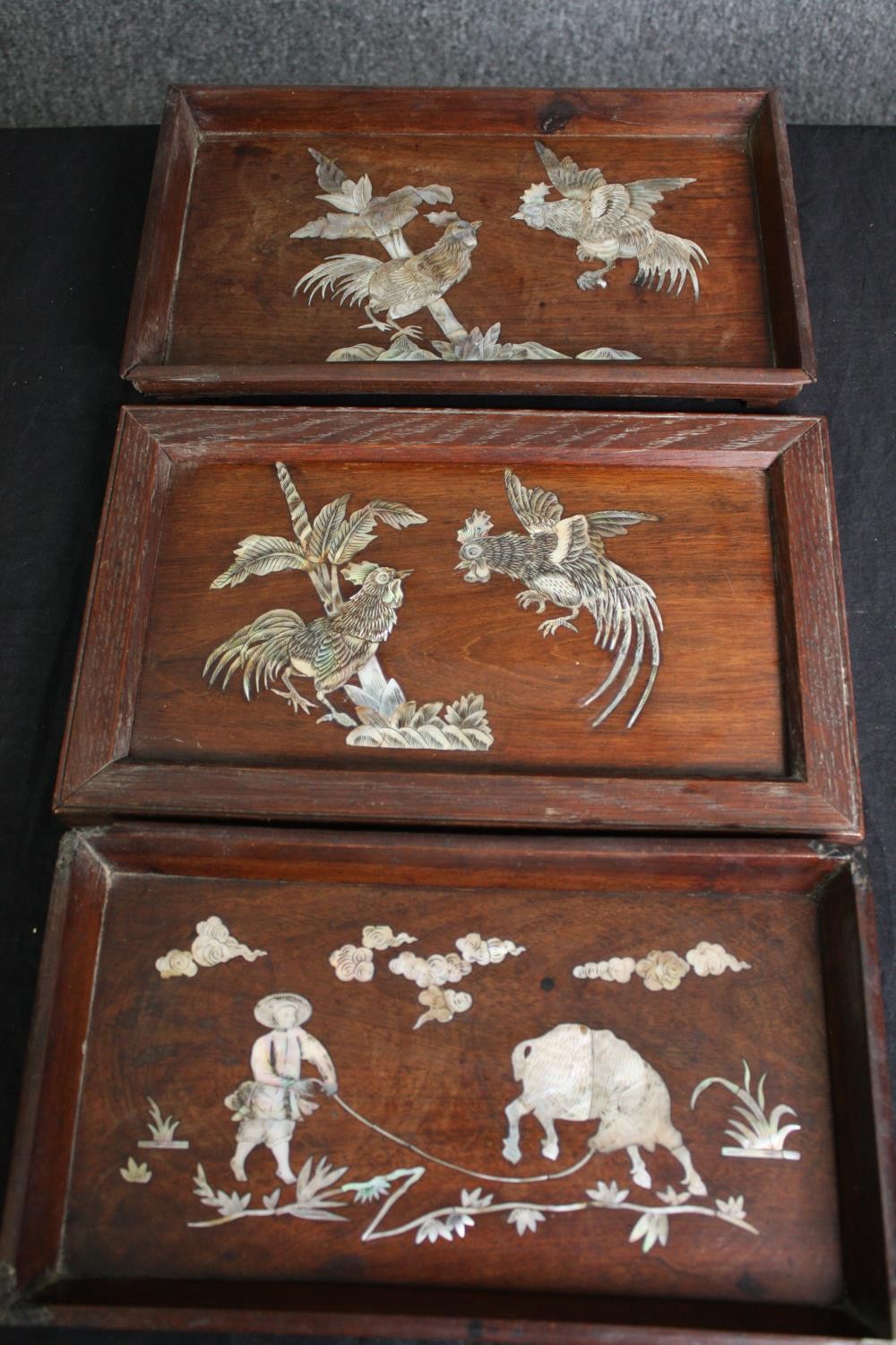 A collection of three Chinese panels or trays with bone inlaid decoration. H.19 W.32cm. (largest).