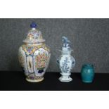 A collection of ceramics, including two early 19th century Delft lidded urns, one (De Porceleyne