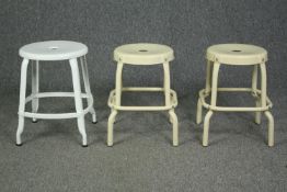 A pair of metal industrial style stools and another similar. H.46cm. (largest)