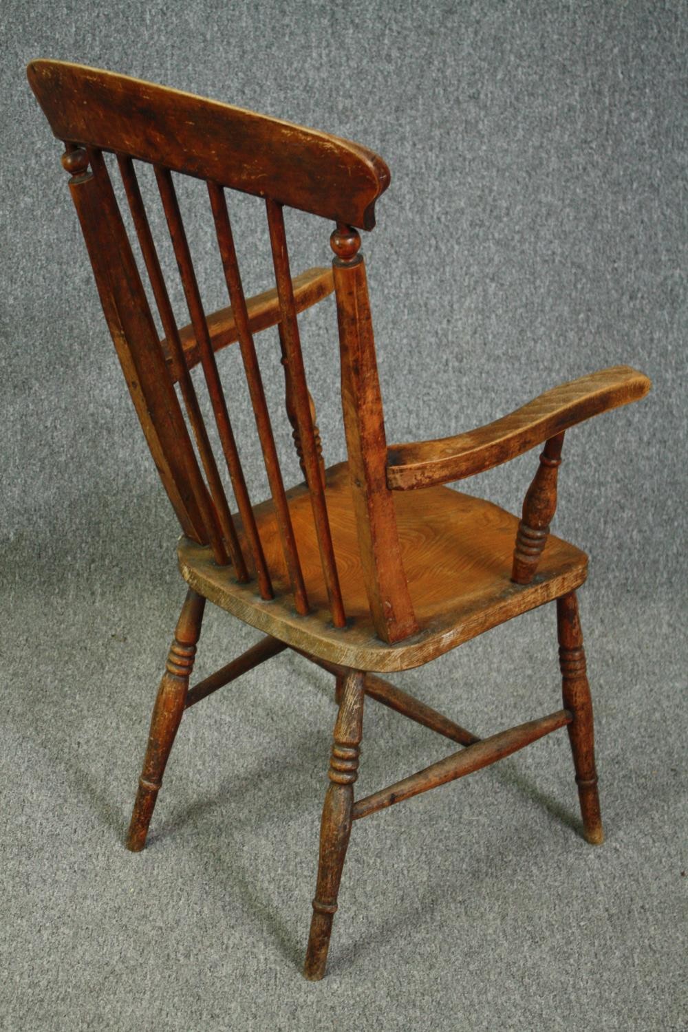 A 19th century elm seated stick back kitchen chair. - Image 3 of 5