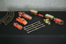 A collection of tin plate cars and trains along with track. L.33cm. (largest).