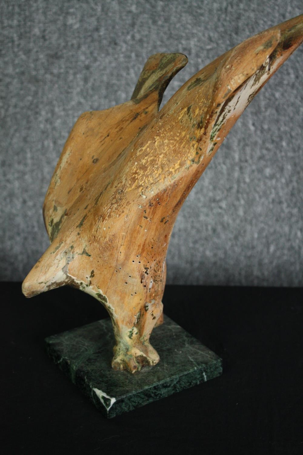 A carved wooden figure of a diving hawk on a marble base. H.35cm.