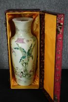 A boxed early 20th century Chinese hand painted Famille rose porcelain vase decorated with banana