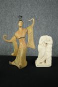 A ceramic dancing Geisha and a carved stone figure. H.31cm. (largest)