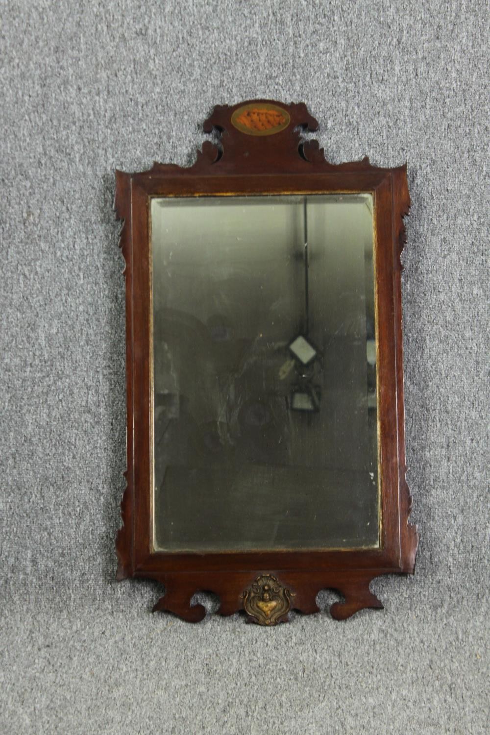 A Georgian mahogany inlaid wall mirror. (Some fret carving missing). H.82 W.46cm.