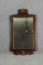 A Georgian mahogany inlaid wall mirror. (Some fret carving missing). H.82 W.46cm.
