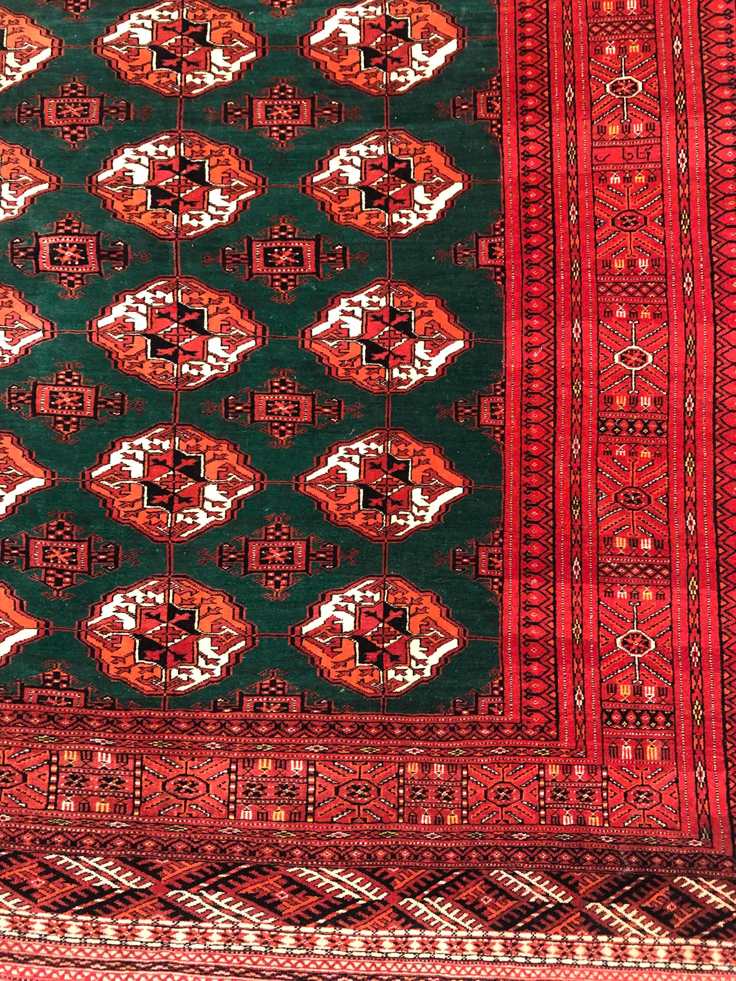 A Bokhara carpet with repeating gul motifs across the field within broad multiple stylised - Image 2 of 4