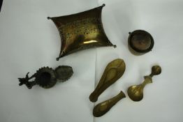 An early 20th century pierced brass cricket cage along with an Indian oil lamp, three spoons and a