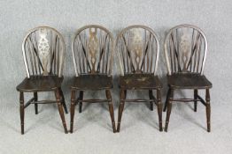 A set of four beech Windsor wheel back kitchen chairs.