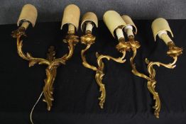 A pair of Rococo style brass twin branch wall sconces along with a gesso example. H.50cm. (largest).