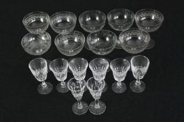 A collection of Edwardian etched wine glasses along with cut crystal sherry glasses. H.11cm. (
