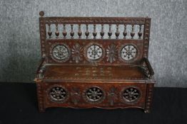 A C.1900 Breton miniature bench with lift up seat. H.25 W.32cm.
