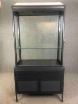 A contemporary two section shop display cabinet. H.211 W.106 D.51cm.