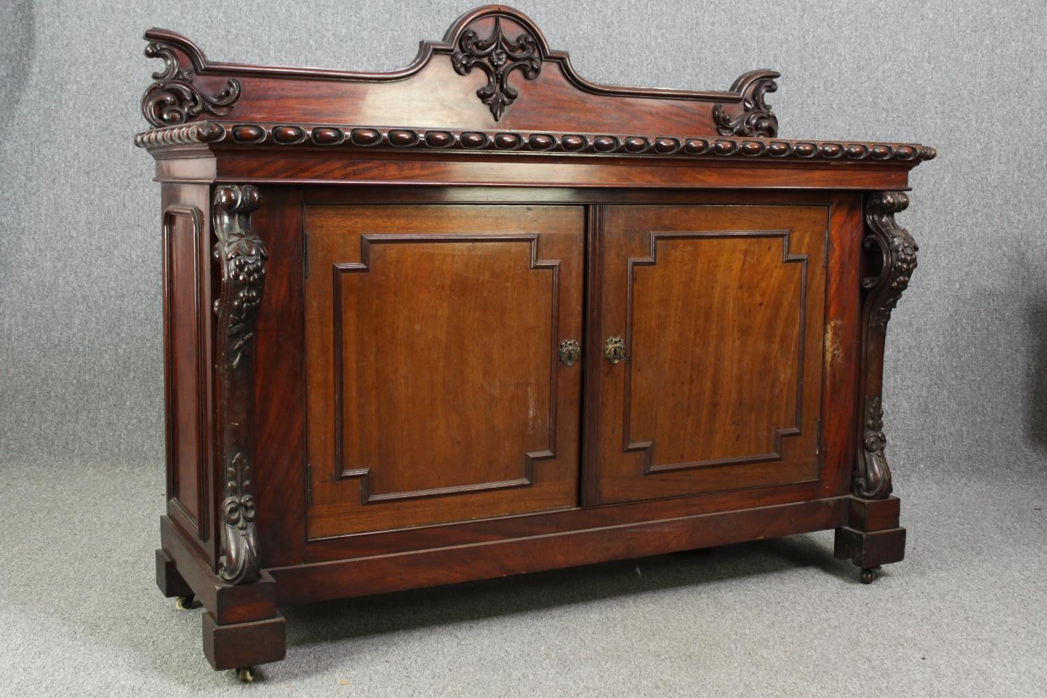 Sideboard, 19th century mahogany with central panelled doors flanked by fruit carved pilasters on - Image 5 of 9