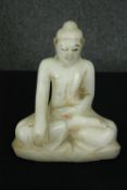 A seated alabaster Buddha figure. H.26cm.