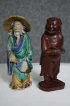 Two Eastern figures, one ceramic the other carved hardwood. H.15cm. (largest).