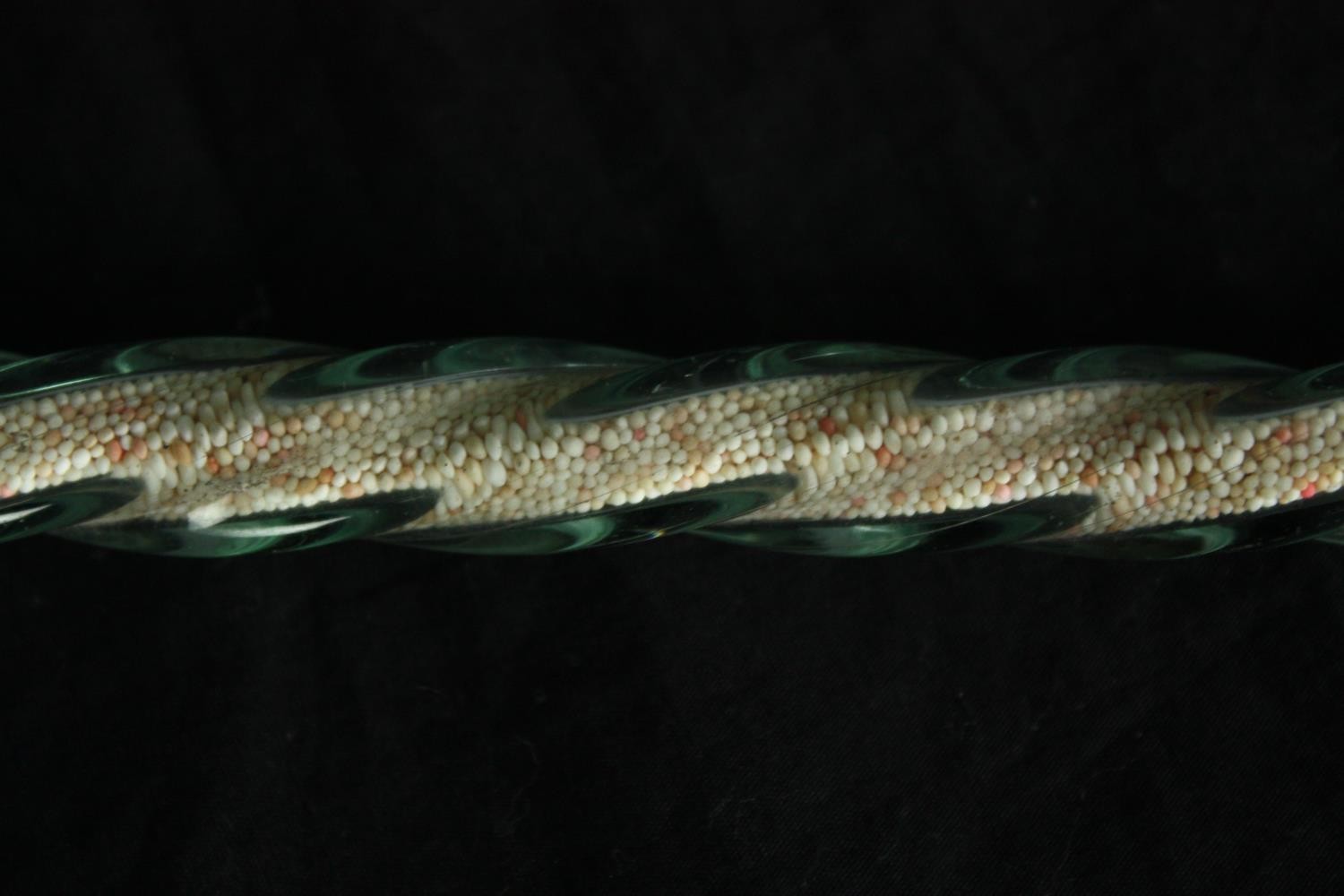 A 19th century spiral twist walking stick, probably Nailsea filled with coloured sugar beads. L. - Image 3 of 4