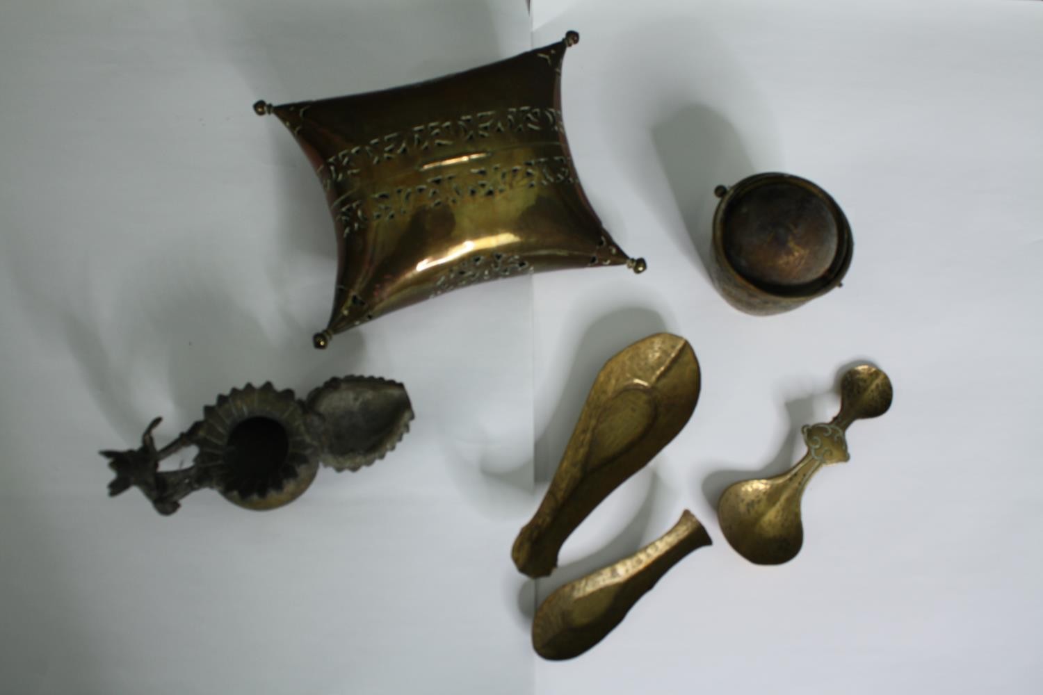 An early 20th century pierced brass cricket cage along with an Indian oil lamp, three spoons and a - Image 2 of 9