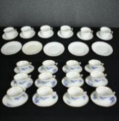 A set of twelve French blue and white tea cups and saucers and a set of six vintage Colclough tea