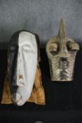 A Congolese Kifwebe Songye mask along with a painted tribal mask. H.55cm. (largest).