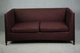 A contemporary tub form sofa with ebonised frame. H.87 W.175 D.92cm.