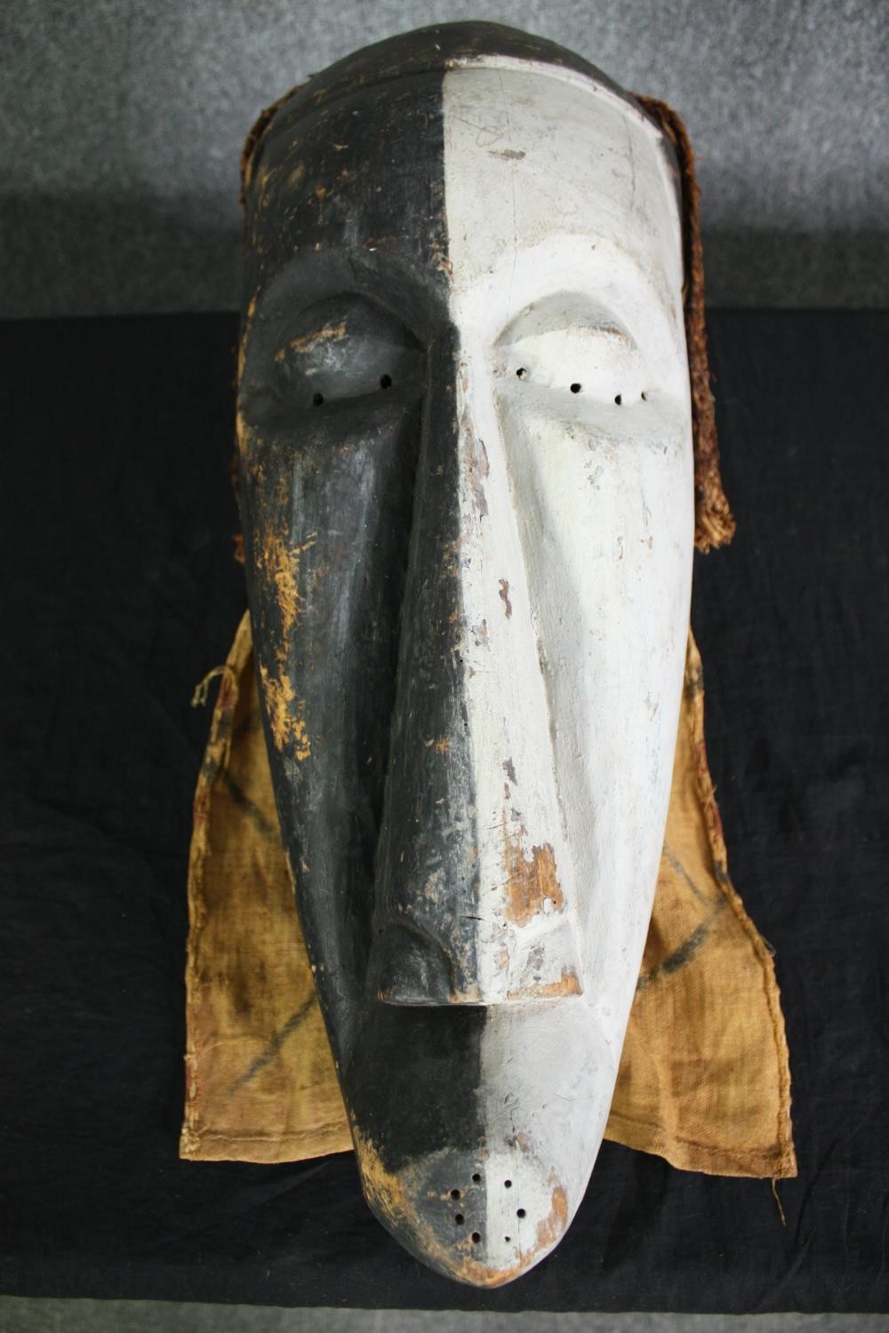 A Congolese Kifwebe Songye mask along with a painted tribal mask. H.55cm. (largest). - Image 2 of 10