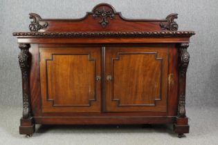 Sideboard, 19th century mahogany with central panelled doors flanked by fruit carved pilasters on