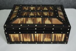 An early 20th century Anglo Ceylonese ebony and bone inlaid porcupine quill box containing a